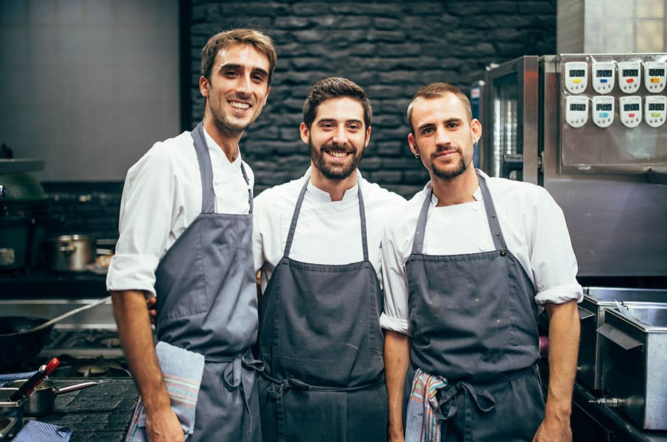 Portrait of three cooks in the kitchen of a restaurant